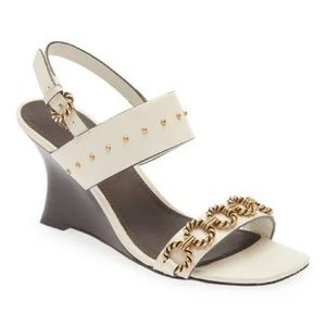 Tory Burch wedge sandals. Leather lining. Leather outsole.Boutique
